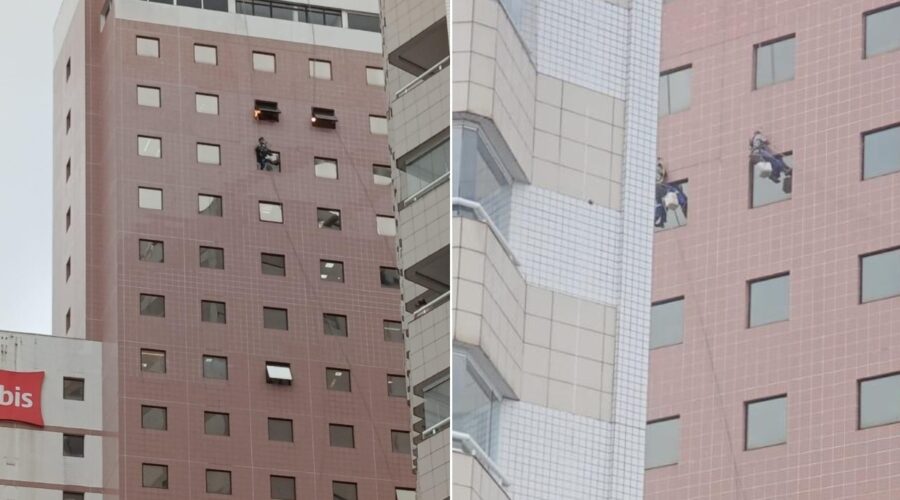 Trabalhadores ficam pendurados em fachada de hotel durante ventania de no litoral de SP; VEJA
